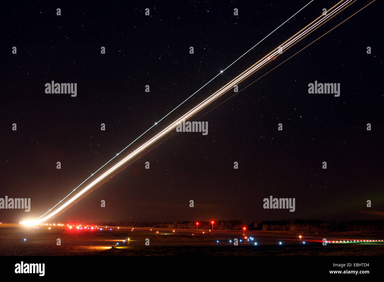 Light trails from an airliner taking off in the night from Skavsta airport, Sweden. Stock Photo