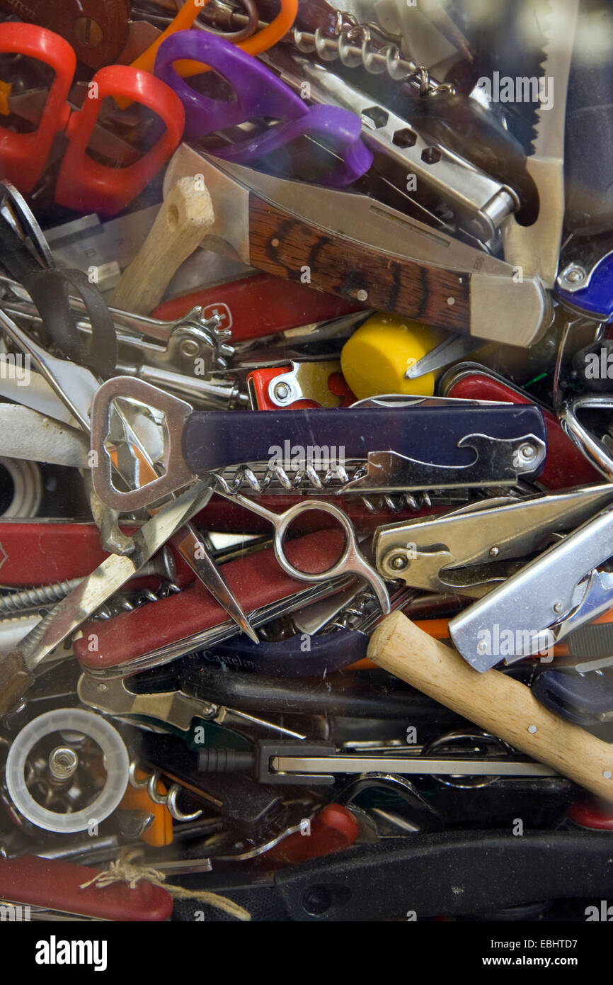 Sharp objects like knives and scissors confiscated at the security control at an airport. Stock Photo