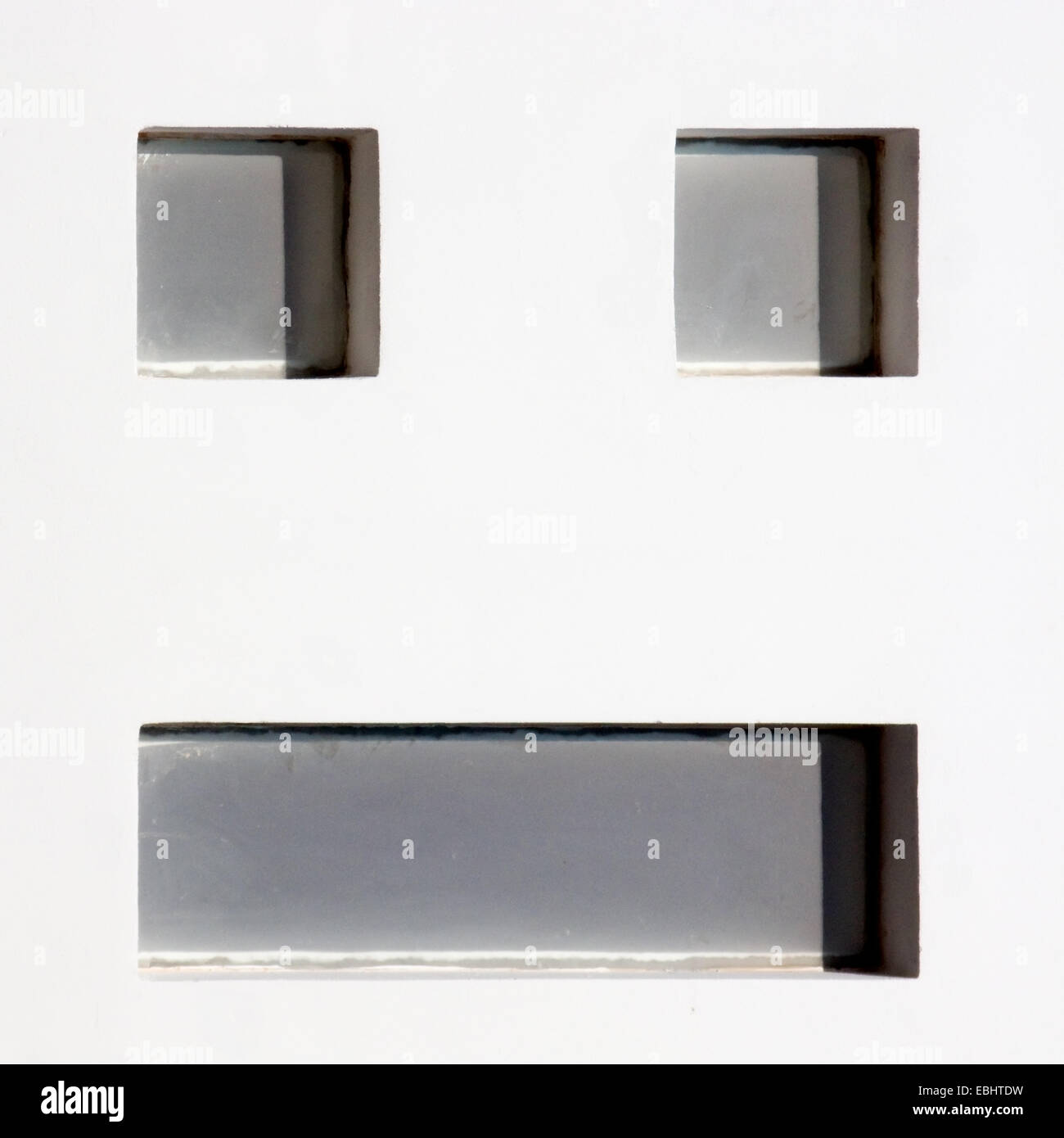 Smiley windows. Windows on a wall looking like a smiley. Stock Photo