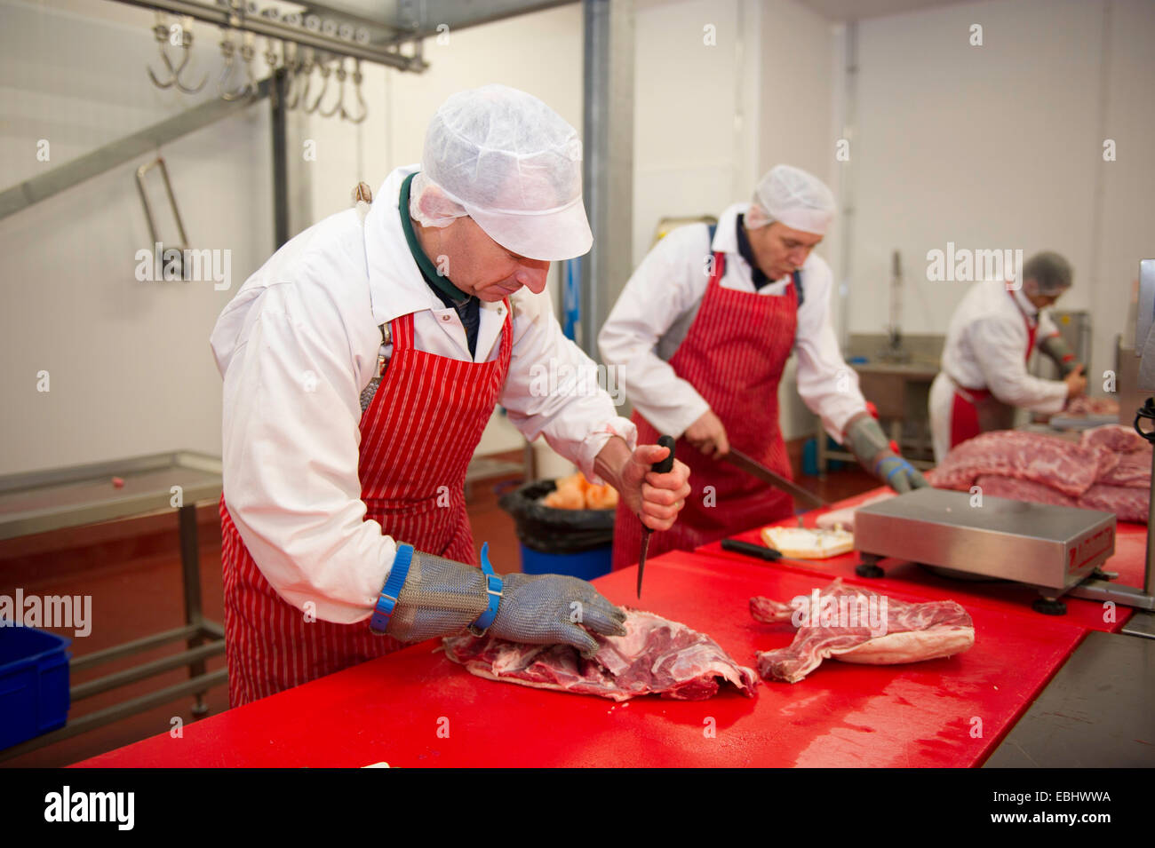 Butchers at work in a factory Stock Photo