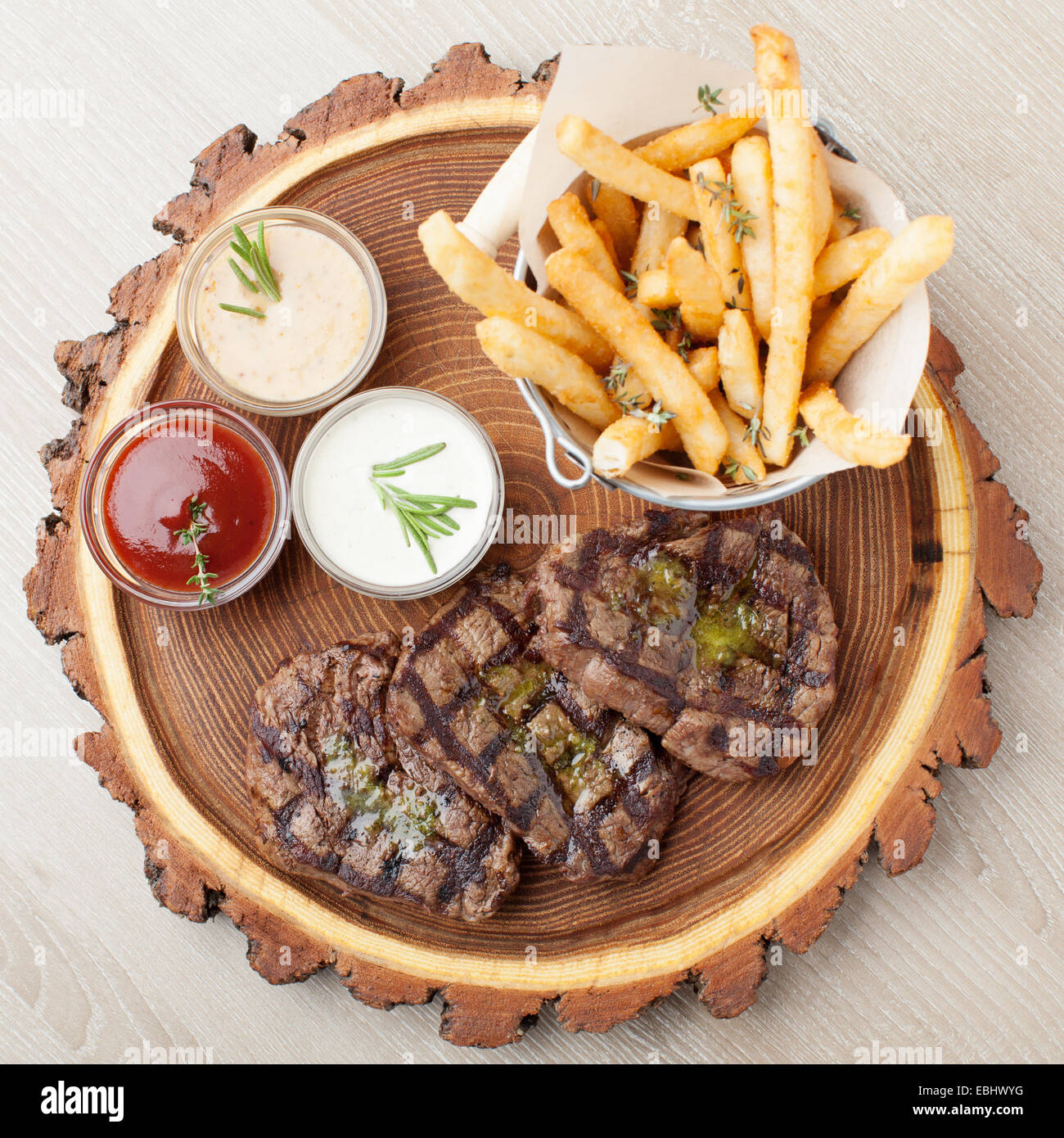 Portion of BBQ beef filet mignon steak served on wooden board with