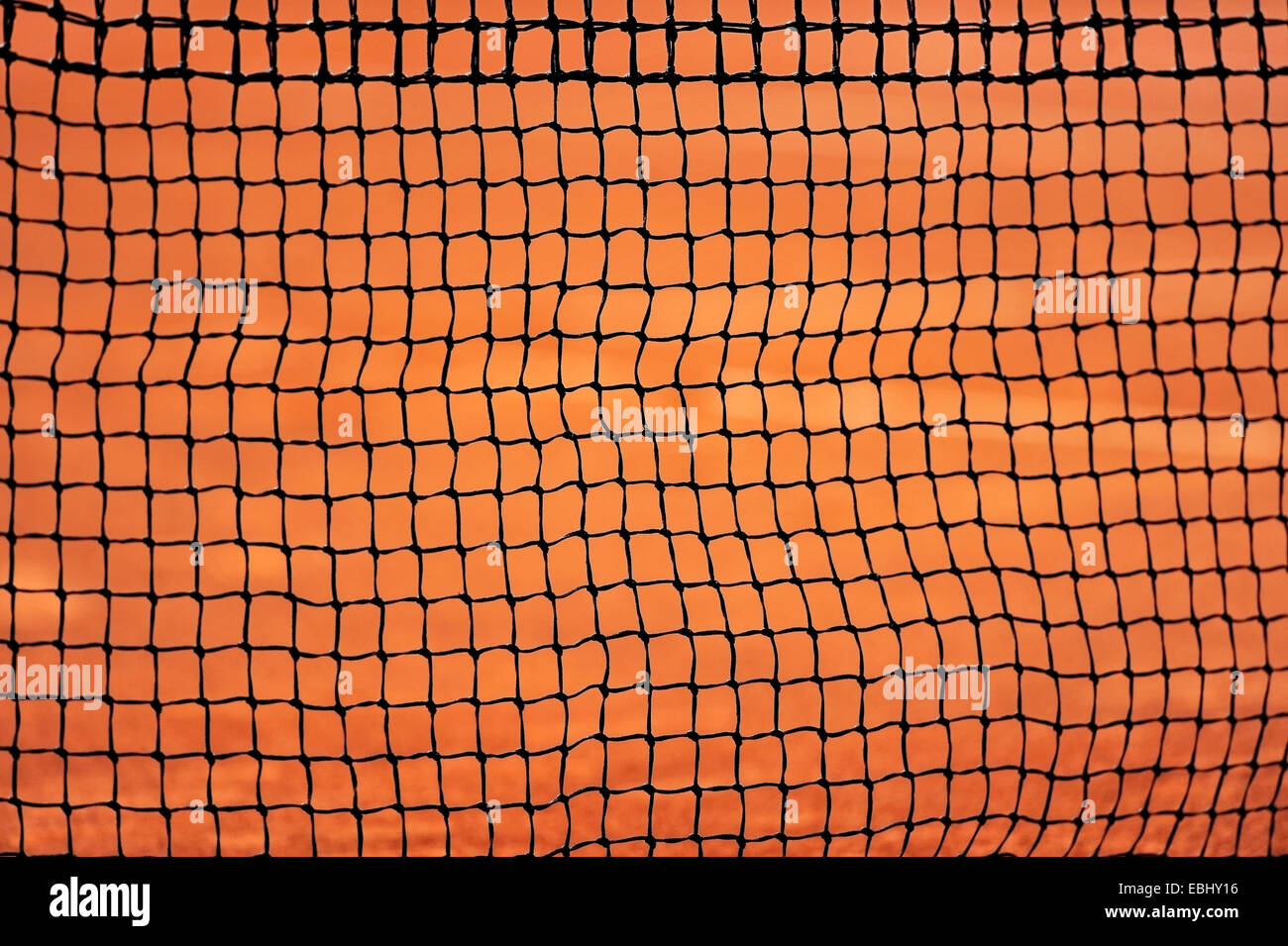 Sport detail shot with a tennis net on a clay court Stock Photo