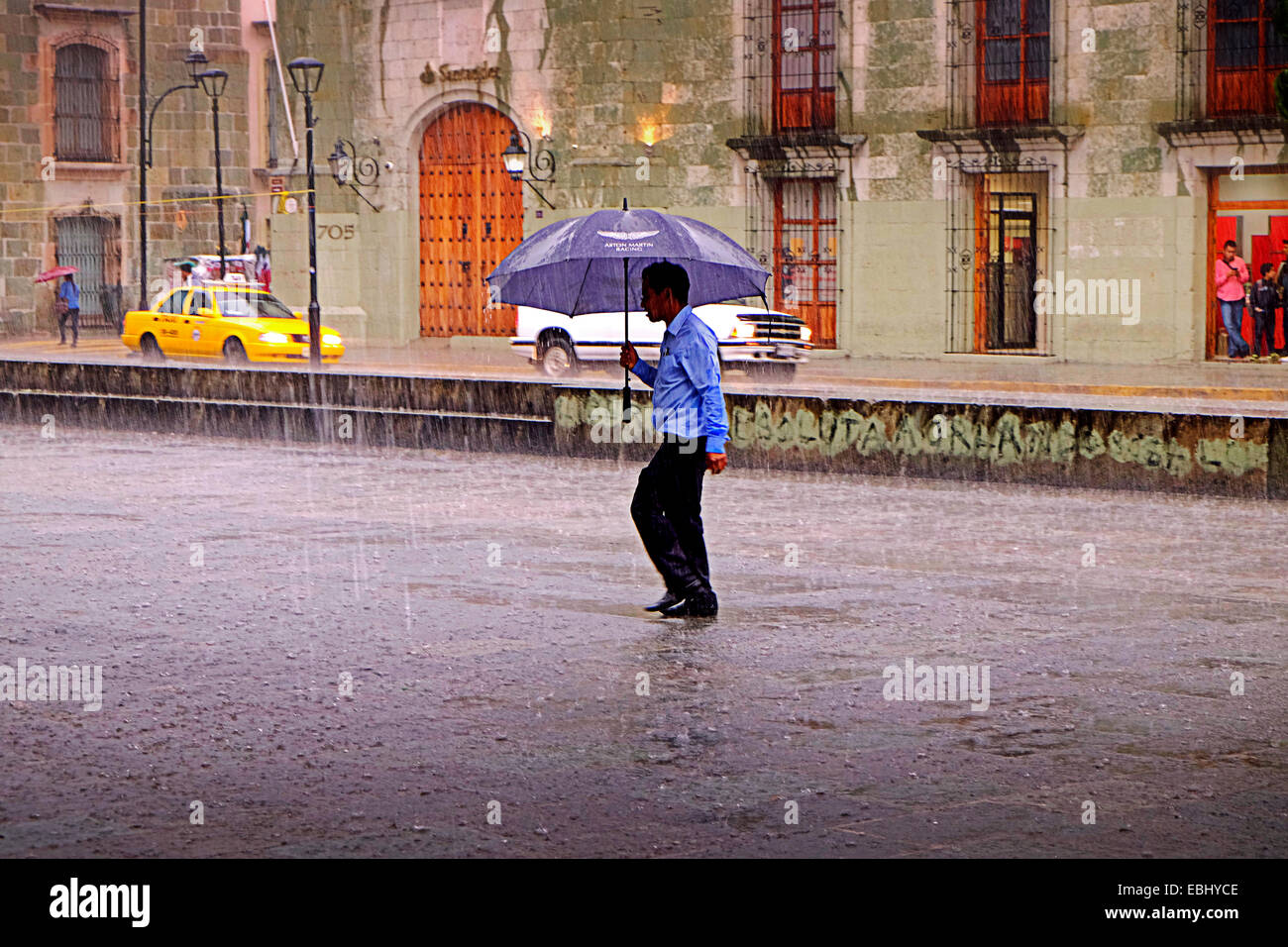Man in tropical rain storm Oaxaca City centre Mexico Stock Photo Alamy