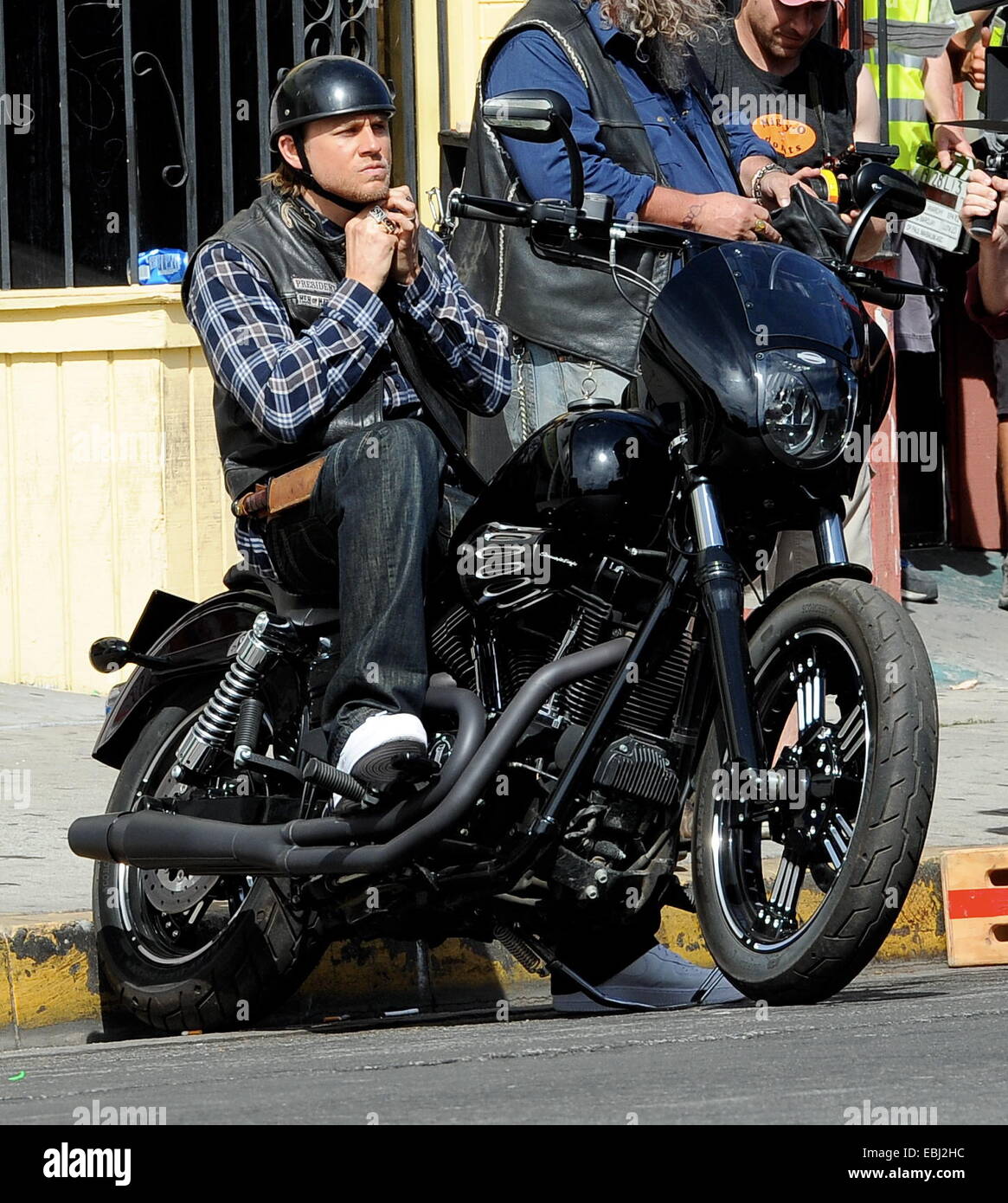 Charlie Hunnam hops on his bike on the set of 'Sons Of Anarchy' after taking time off to film his new movie Crimson Peak in Canada. The uk actor was seen fooling around with the rest of the cast as they film the last season to their hit biker show.  Featu Stock Photo