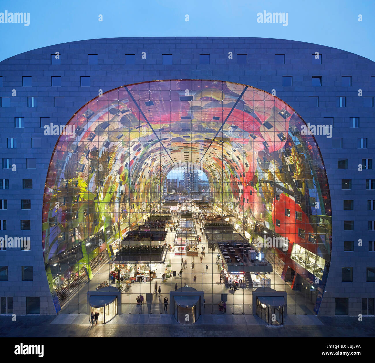 Market Hall Rotterdam, Rotterdam, Netherlands. Architect: MVRDV, 2014. View through illuminated market hall at dusk. Stock Photo