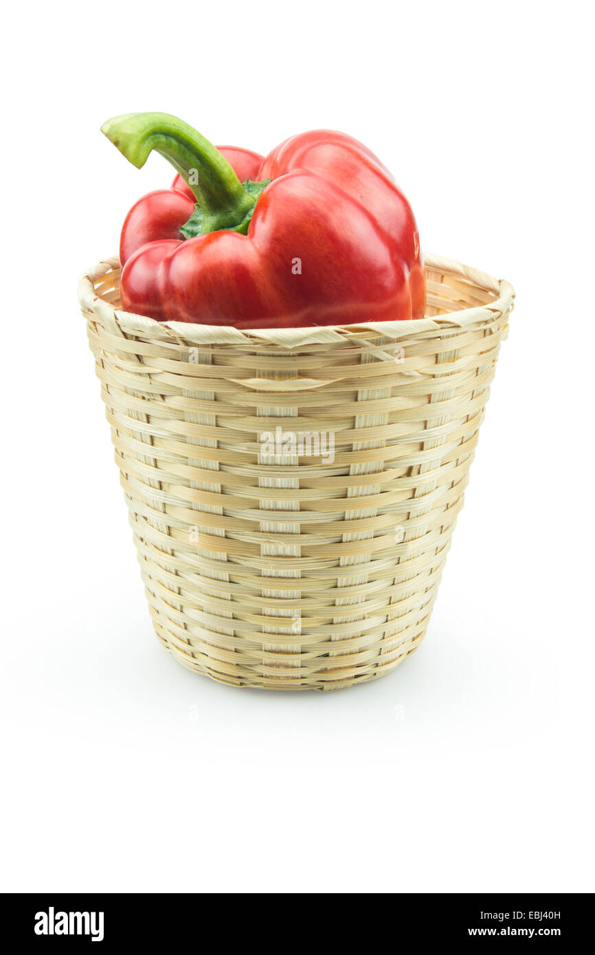 Red Paprika pepper in bamboo basket isolated on white background Stock Photo