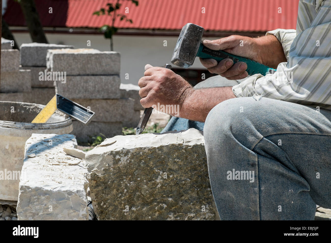 Close-up of a Stonemason at work. Photographed in Greece Stock Photo
