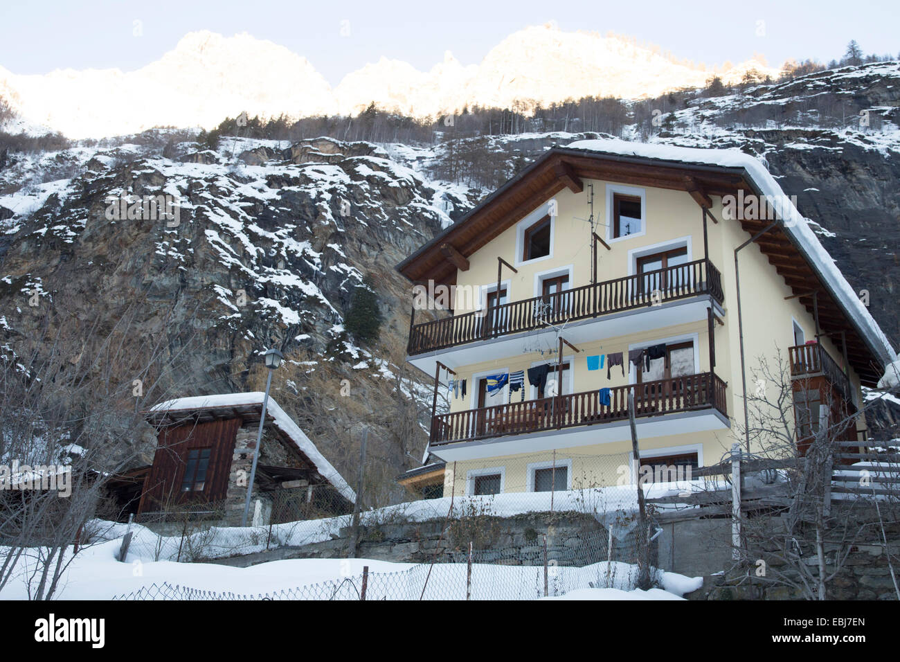 Alpine ski lodge, wooden house in Italian Alps. Snowcovered mountain