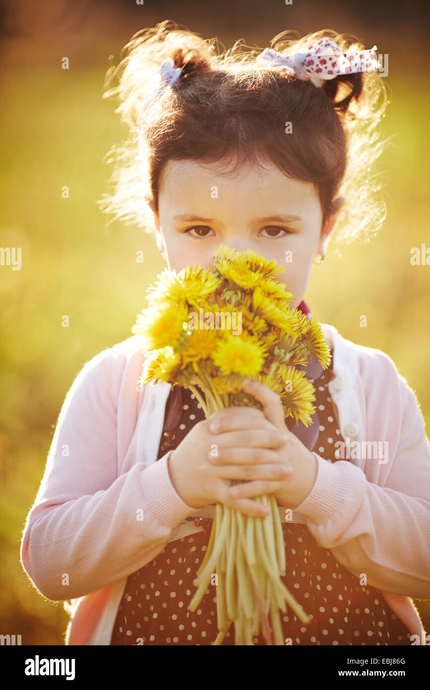 cute little girl with dandelions Stock Photo - Alamy