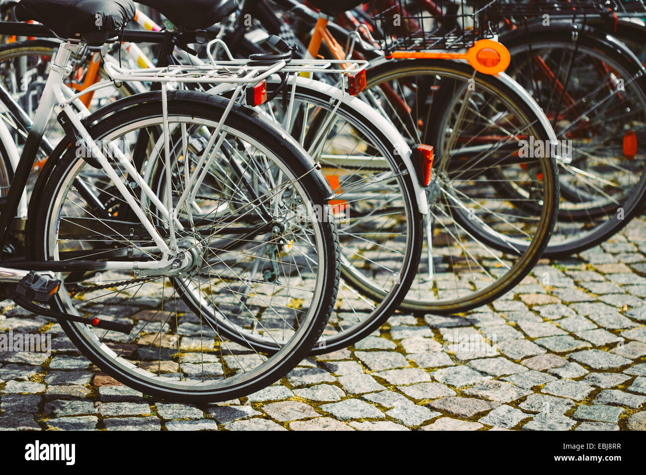 Parked Bicycles On Sidewalk. Bike Bicycle Parking In Big City. Toned Instant Photo Stock Photo