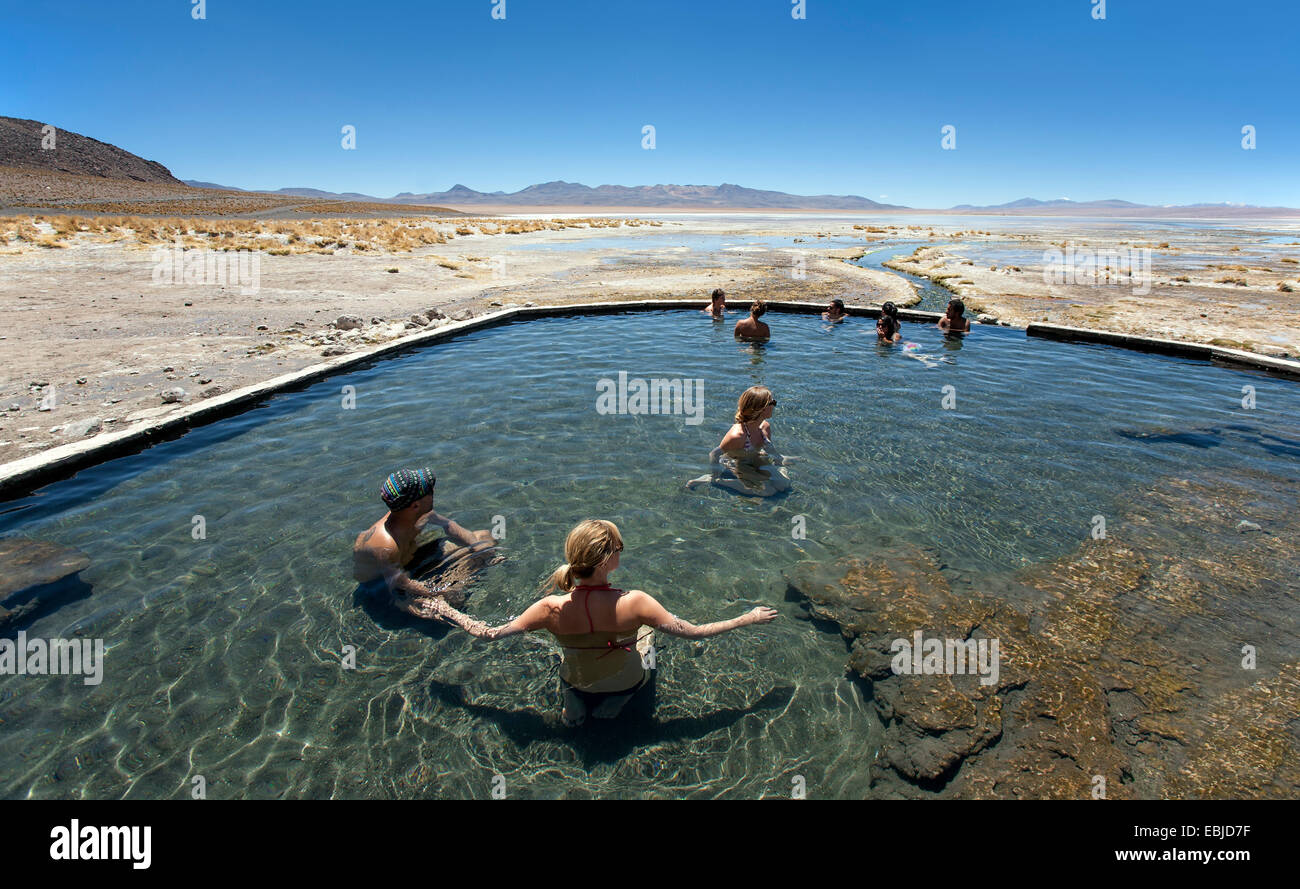 Tourists at the Polques hot springs. Chalviri desert (on the Salar de Uyuni tour). Bolivia Stock Photo