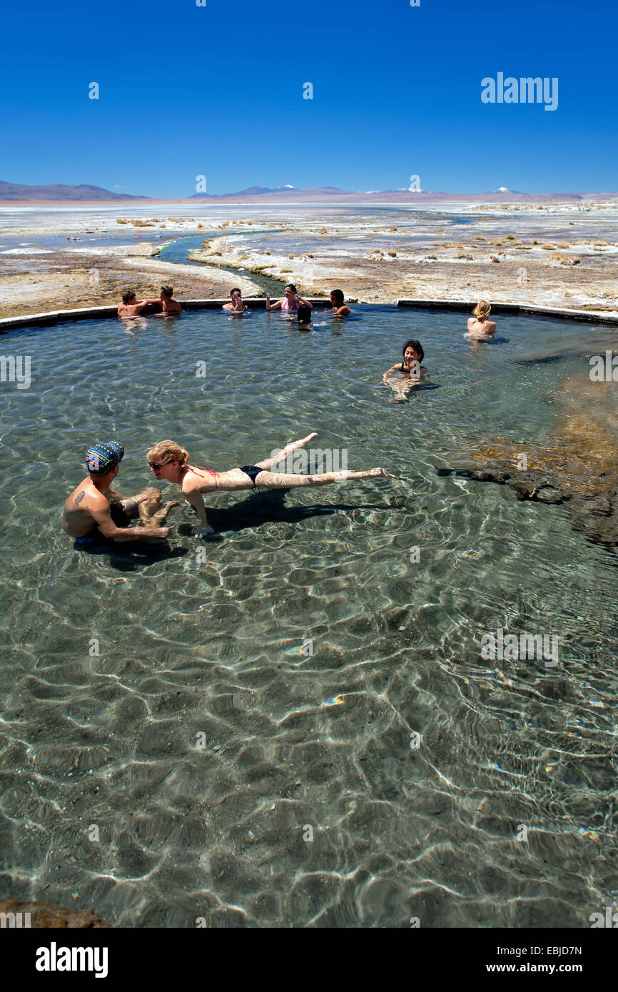 Tourists at the Polques hot springs. Chalviri desert (on the Salar de Uyuni tour). Bolivia Stock Photo