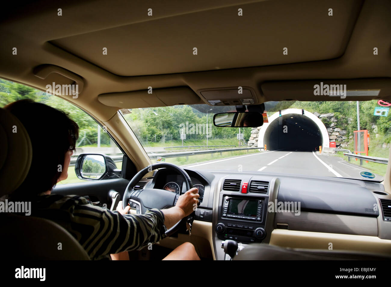 woman drives her car into a tunnel Stock Photo