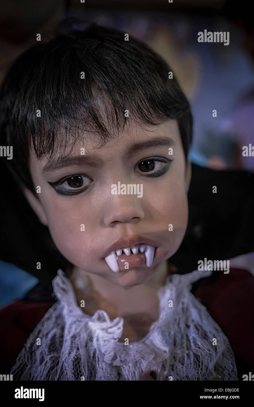 Halloween child with Vampire teeth. Young boy made up as the vampire Dracula at a Halloween festival Stock Photo