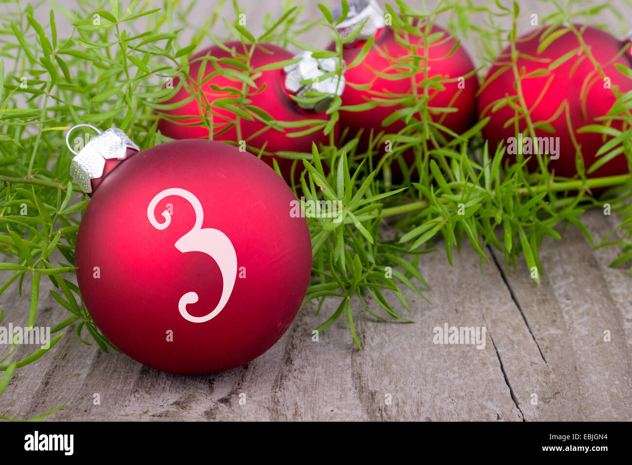 Four red christmas balls with digit three Stock Photo