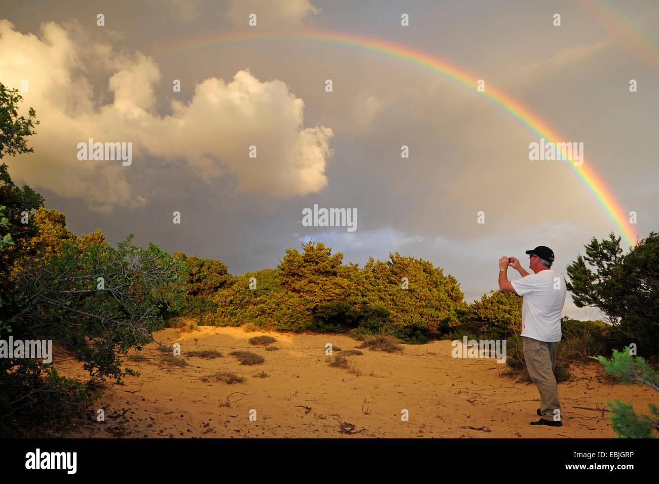 nature photographer picturing the rainbow over the dunes at the West Peloponnese, Greece, Peloponnese, Messenia Stock Photo
