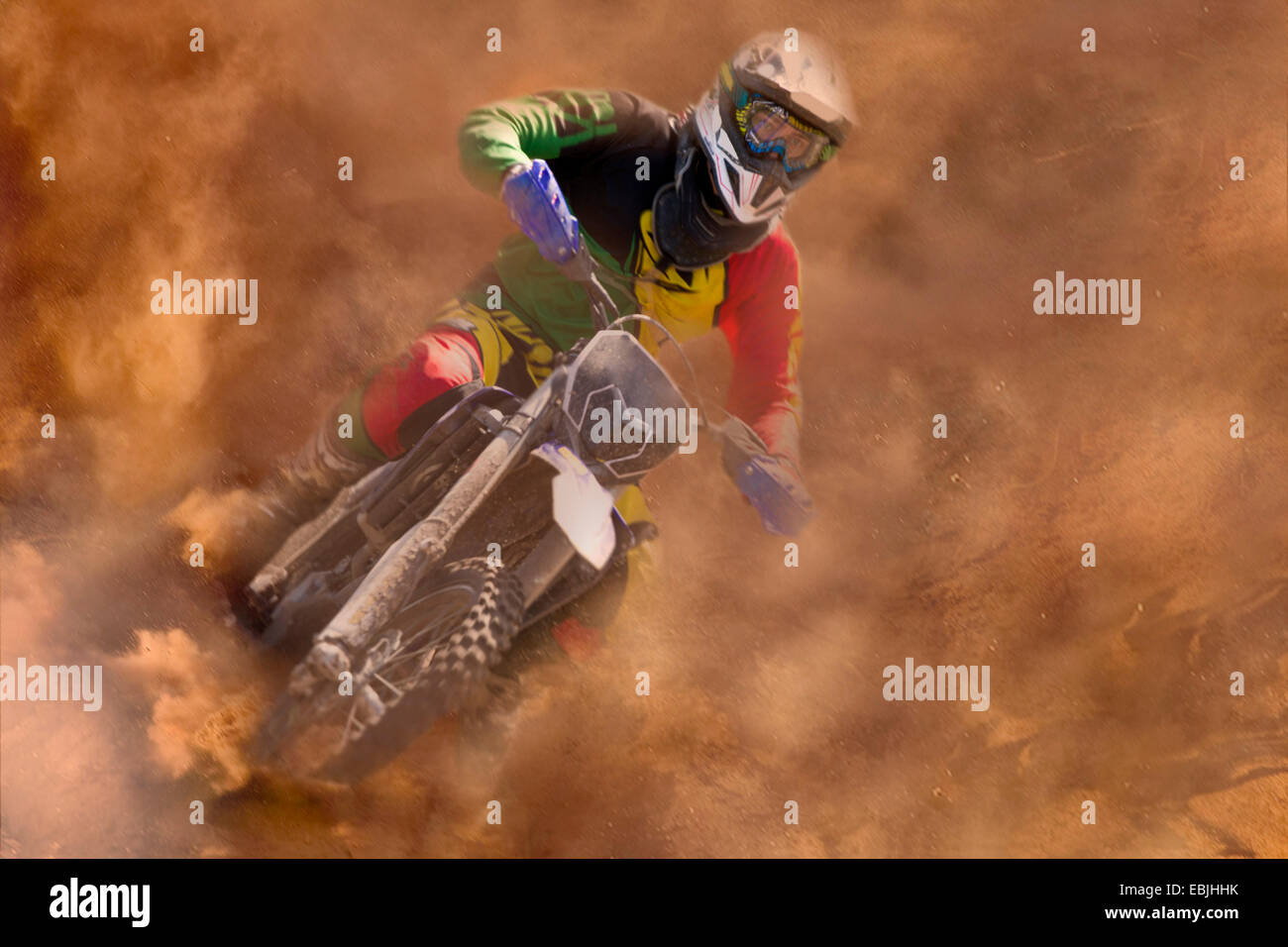 Young male motocross rider racing in dust Stock Photo