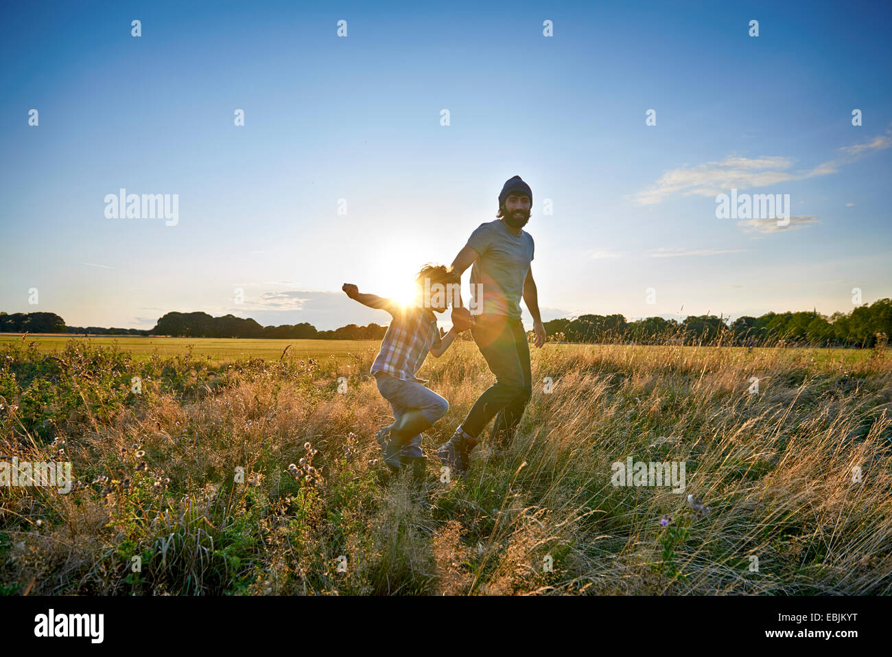 Father and son out walking in the park Stock Photo