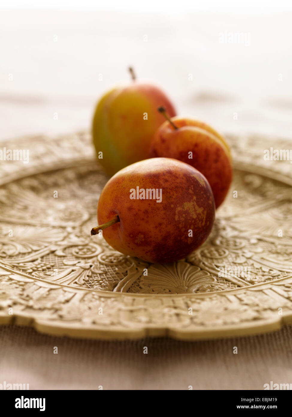 Victoria plums on decorative plate, close-up Stock Photo