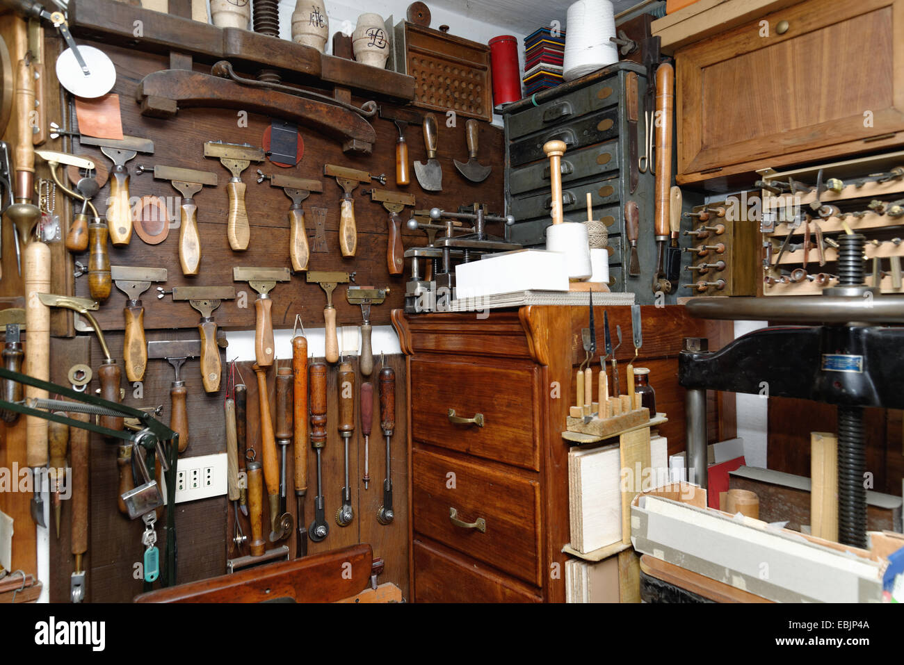Selection of tools and equipment in traditional bookbinding workshop Stock Photo