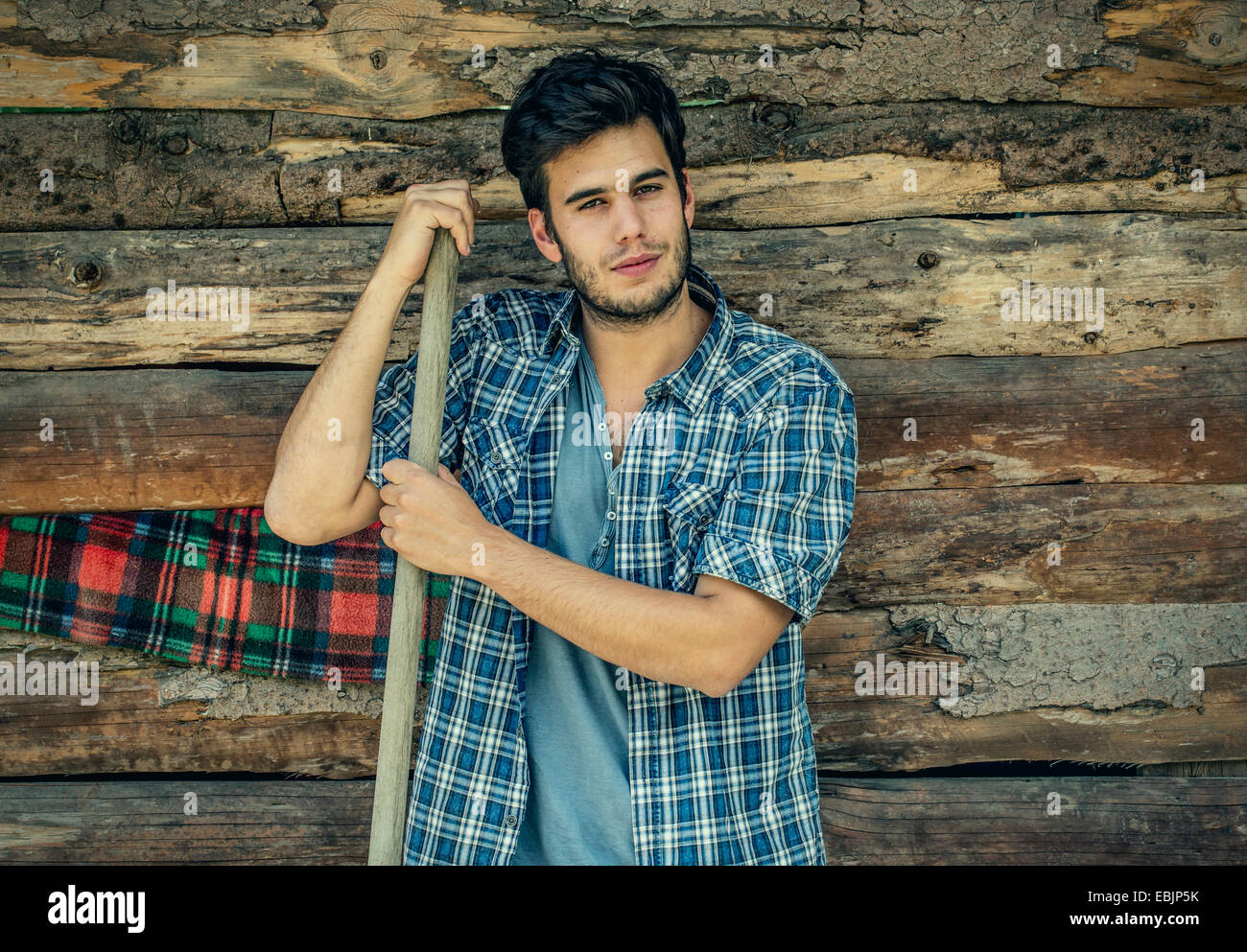 Portrait of young male farmer with pitchfork, Premosello, Verbania, Piemonte, Italy Stock Photo