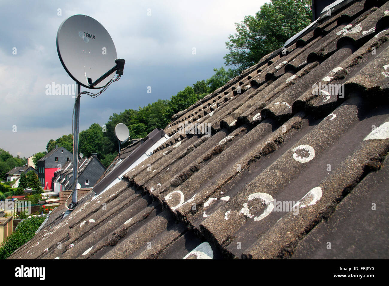 satellite dish on a roof with lichened old roof tiles, Germany, Nordrhein Westfalen, Ruhr Area, Essen Stock Photo