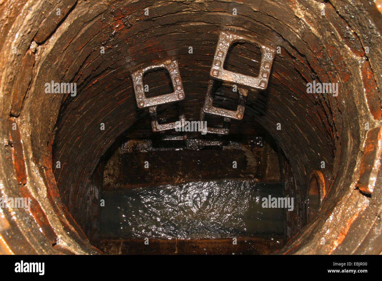 view through a manhole into the canalisation, Germany, Nordrhein Westfalen, Ruhr Area, Essen Stock Photo