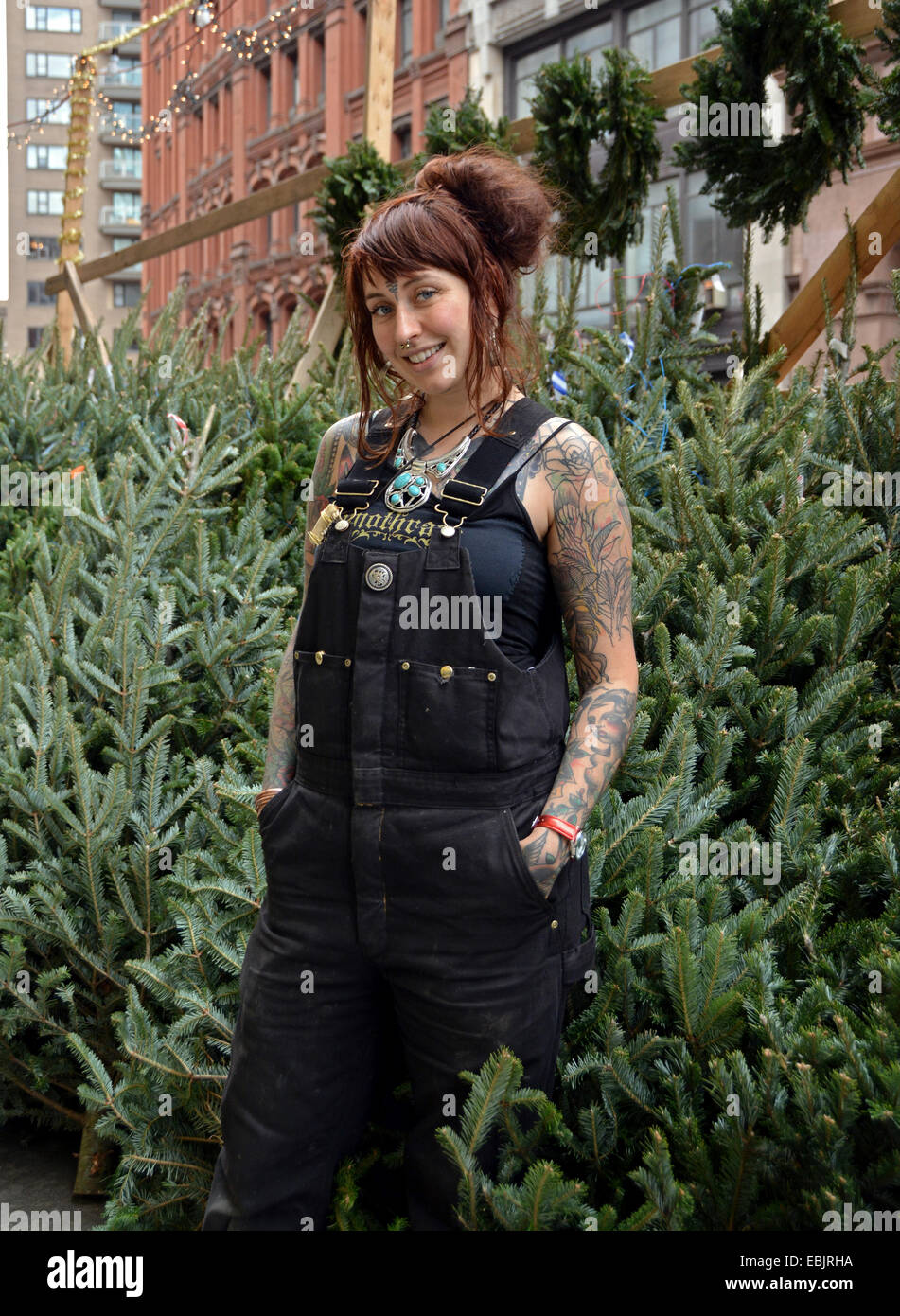 Portrait of a Scottish woman with tattoos selling Christmas trees on Astor Place in Greenwich Village, Manhattan, New York City Stock Photo