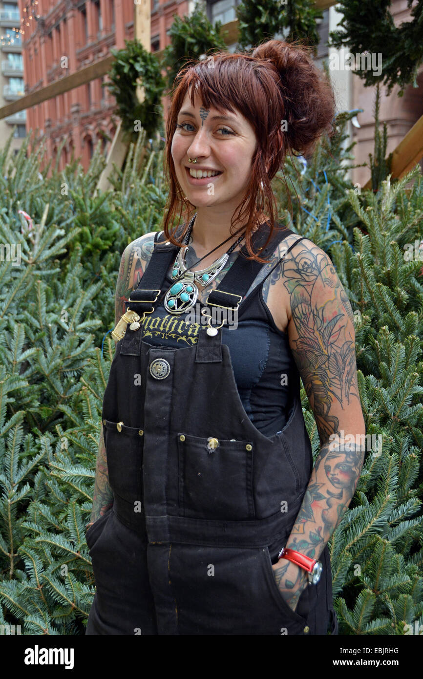 Portrait of a Scottish woman with tattoos selling Christmas trees on Astor Placein Greenwich Village, Manhattan, New York City Stock Photo