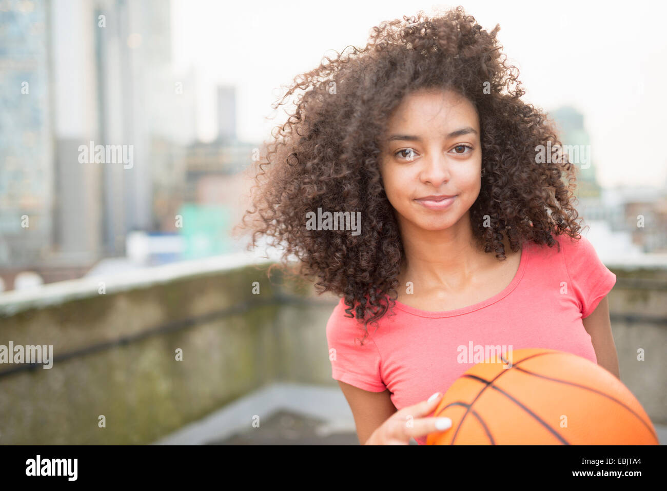 Young woman holding basketball Stock Photo - Alamy