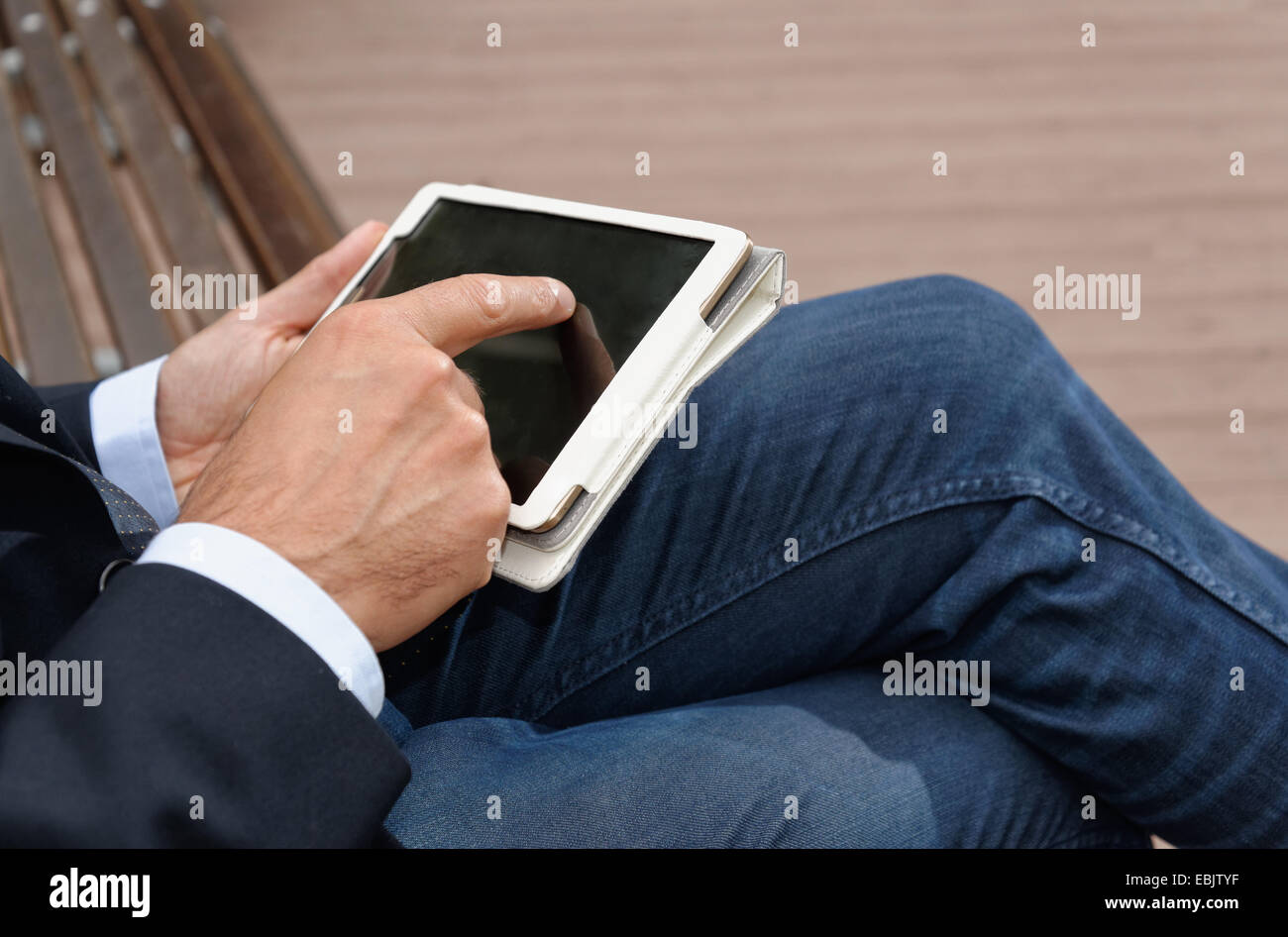 Man using digital tablet, focus on hands Stock Photo