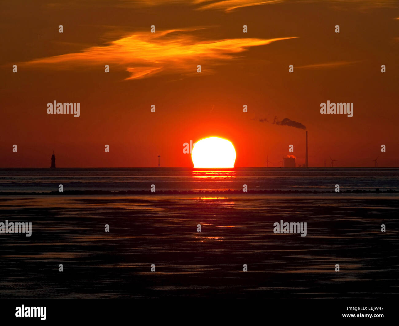 sunset at wadden sea, power station Wilhelmshaven in background, Germany, Wilhelmshaven Stock Photo