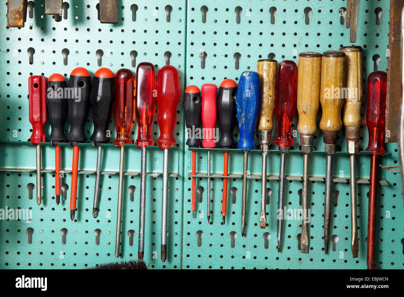 collection of screwdrivers in a workshop cabinet Stock Photo