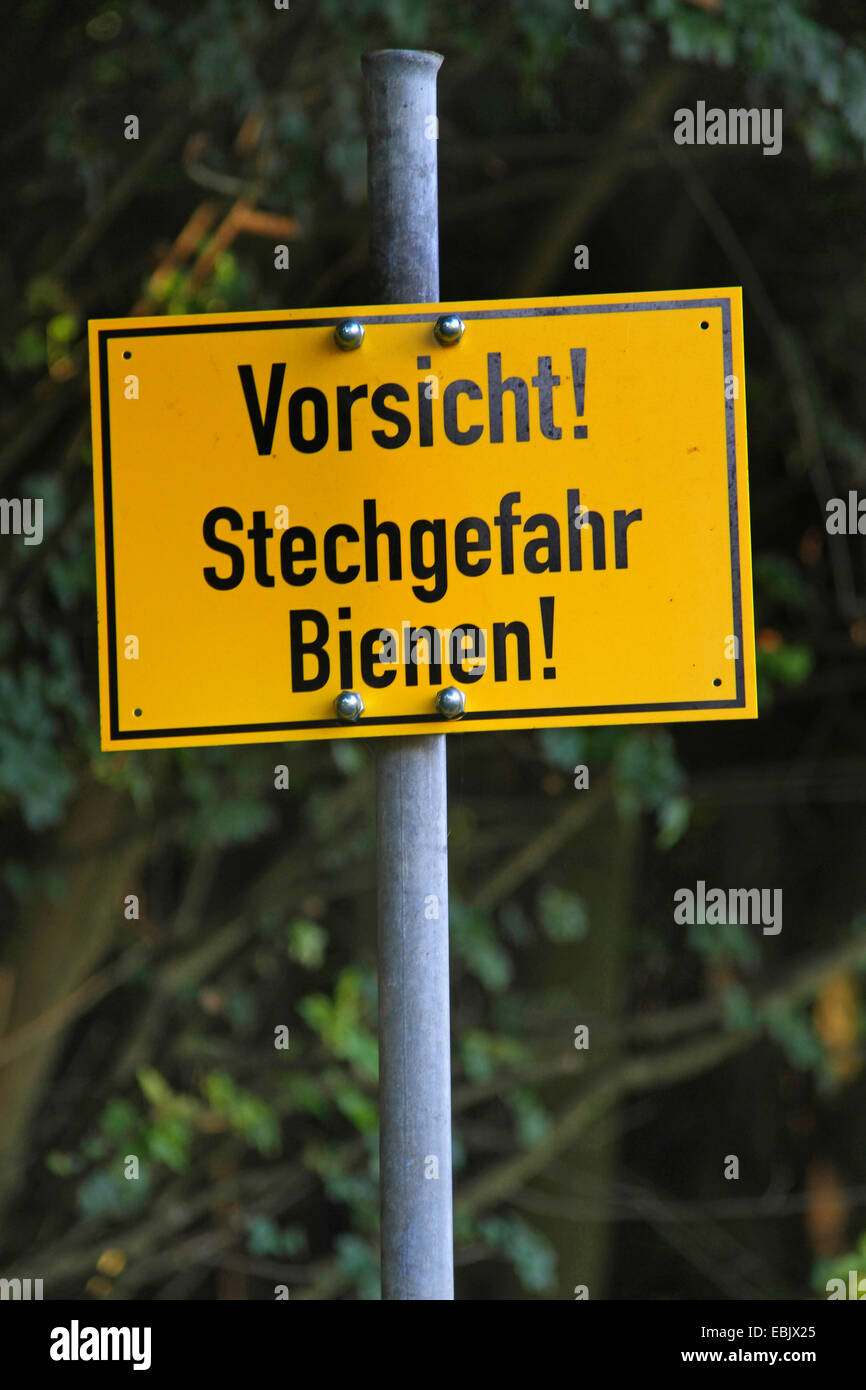 warning sign labeled 'caution! danger of bee stings!', Germany, North Rhine-Westphalia Stock Photo