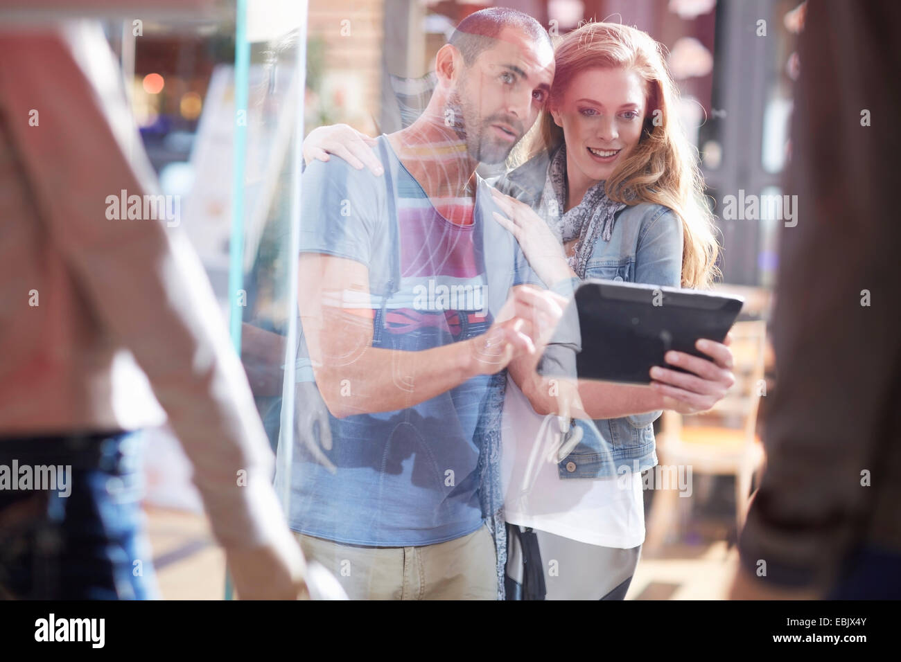 couple window shopping, holding digital tablet Stock Photo