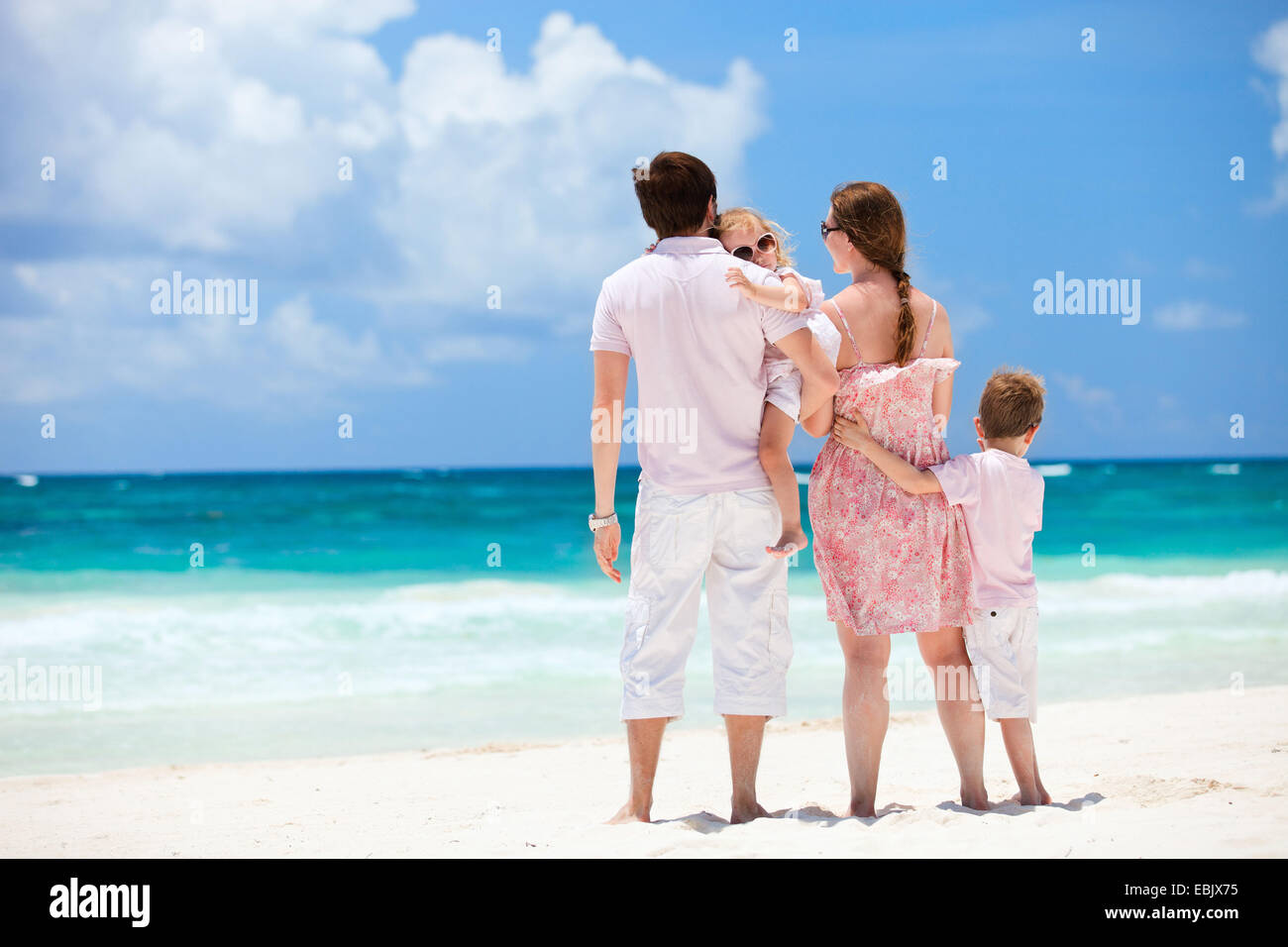 family with two children admiring the view on Caribbean beach, Mexico Stock Photo