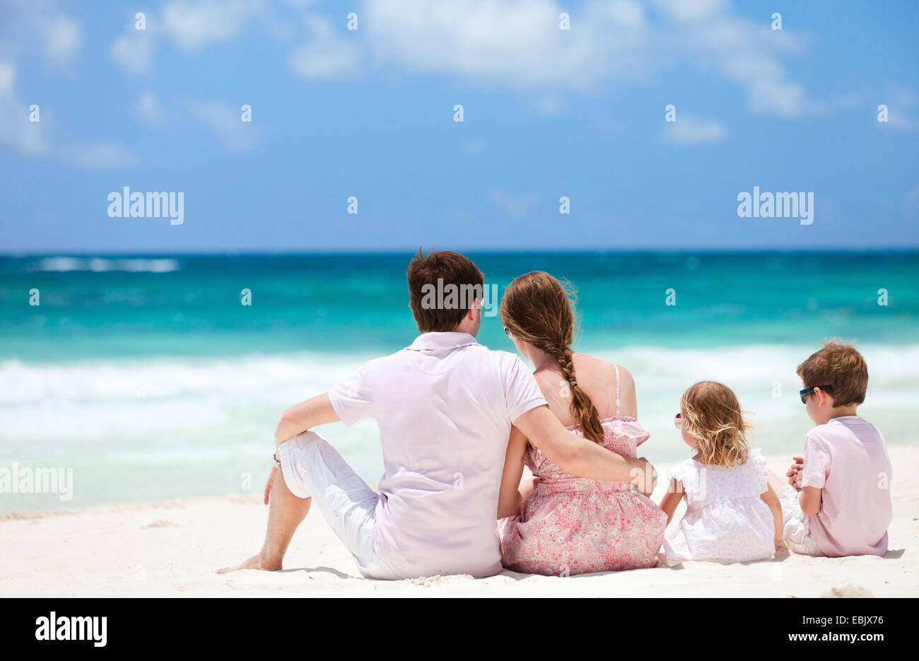 family with two children admiring the view on Caribbean beach, Mexico Stock Photo