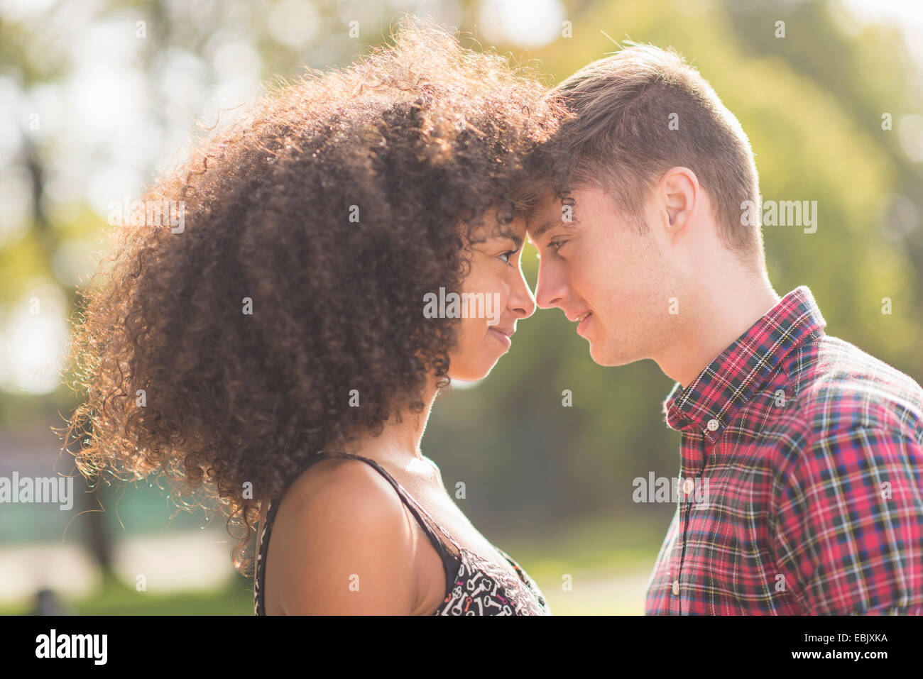 Young couple face to face in park Stock Photo