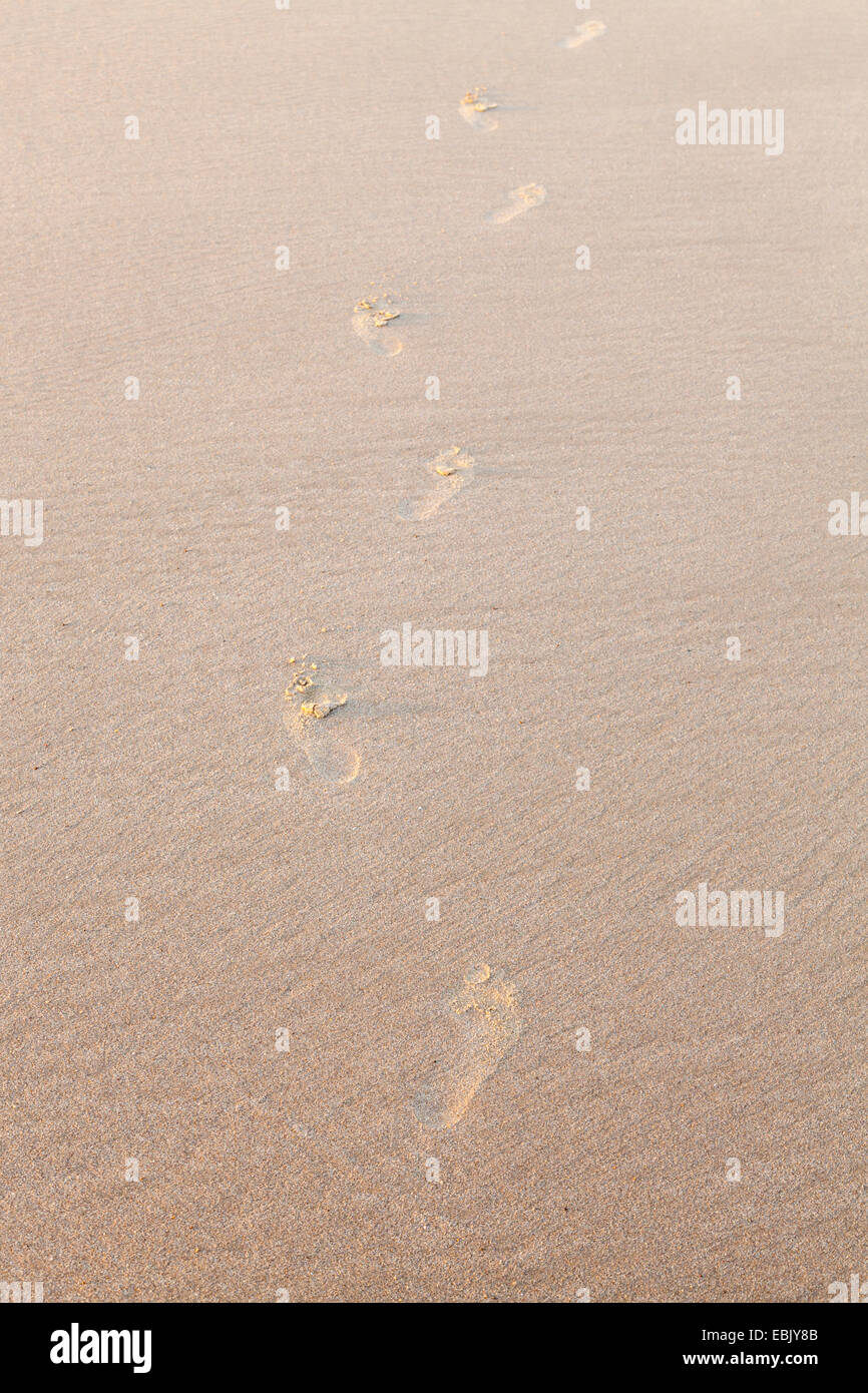 Footprints in sand on a beach, England, UK Stock Photo
