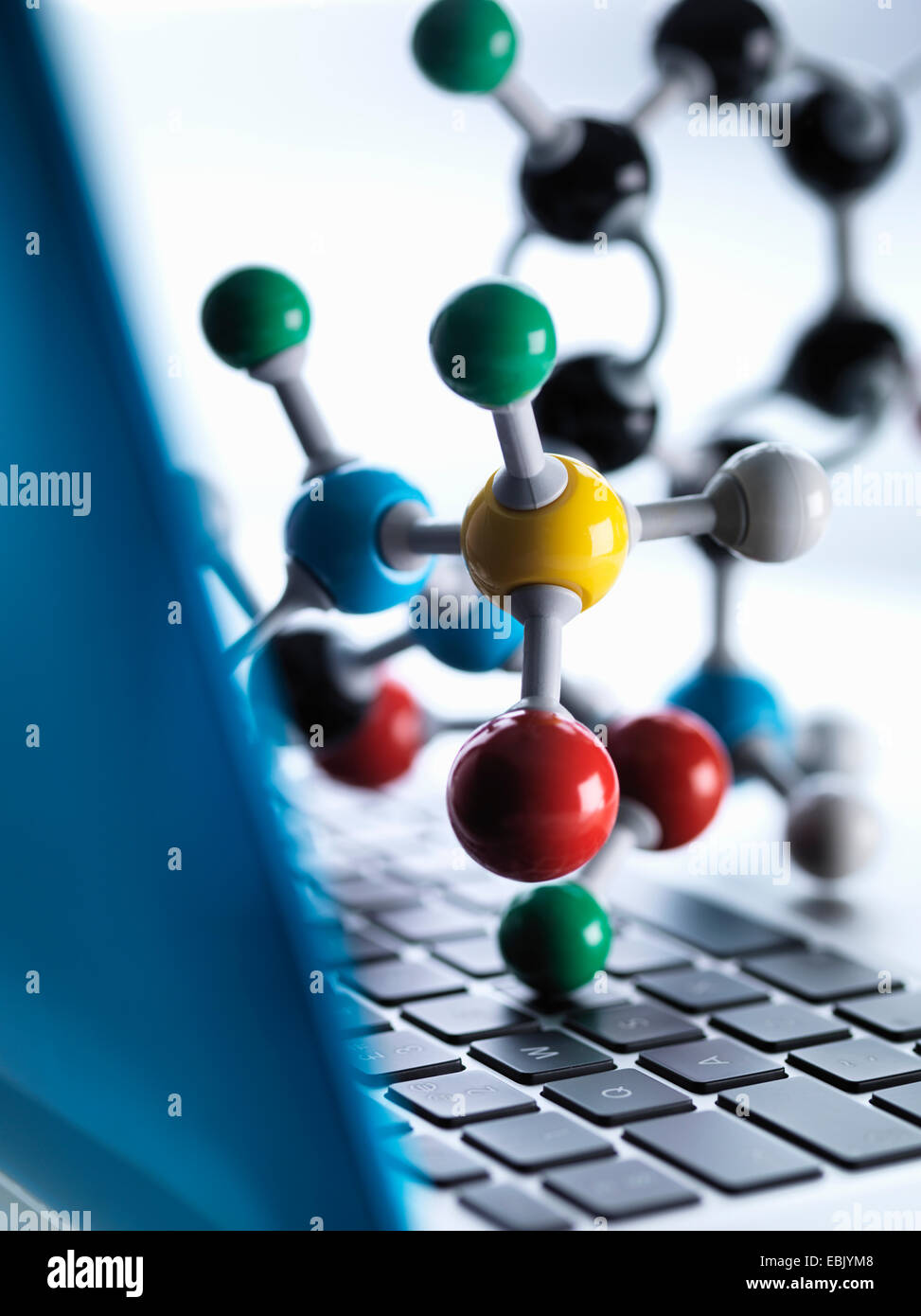 Close up of molecular model sitting on top of lap top computer keyboard to illustrate science education and computer aided research Stock Photo