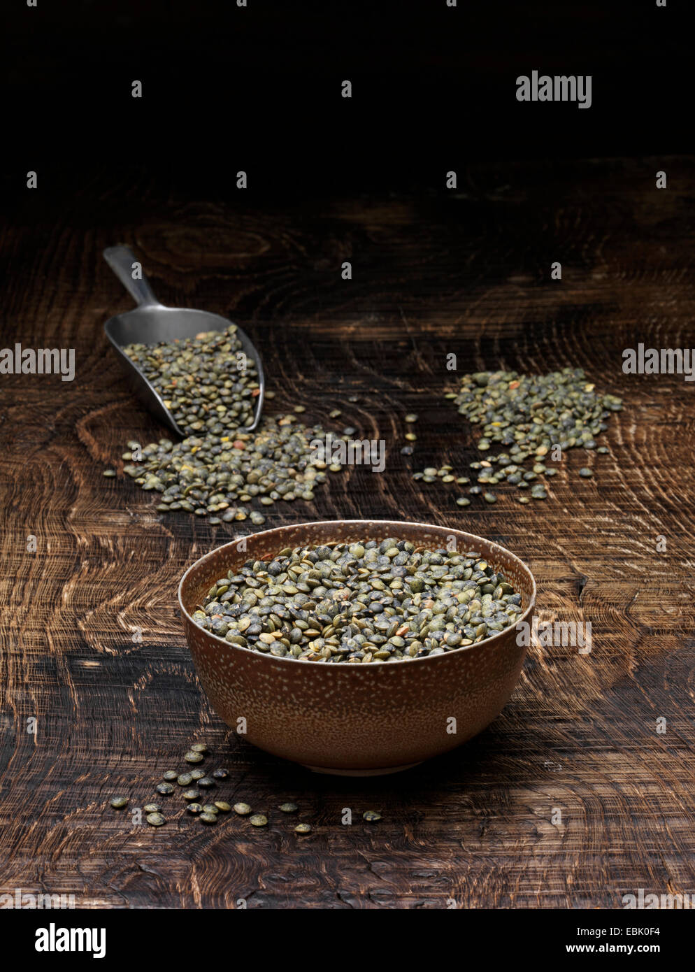 Still life with bowl of puy lentils and scoop Stock Photo