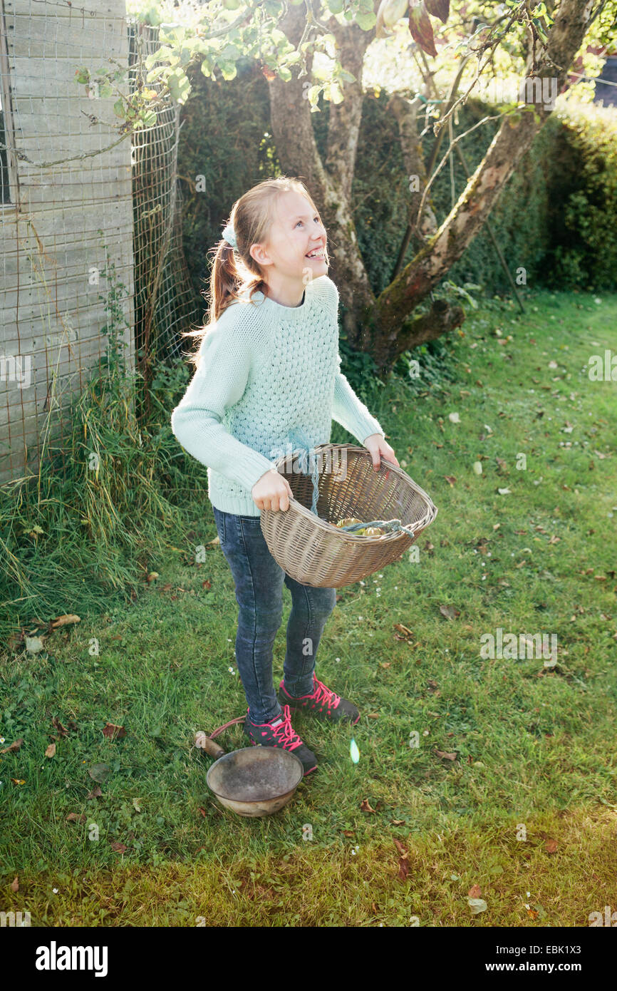 Girl holding basket in garden Stock Photo Alamy