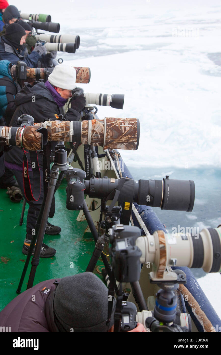 row of cameras on deck of ship ready to photograph Polar bear, Norway, Svalbard Stock Photo