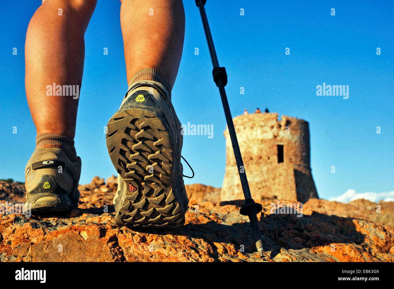 shoes of wanderer in front of Genoese tower, France, Corsica, Capo Rosso Stock Photo
