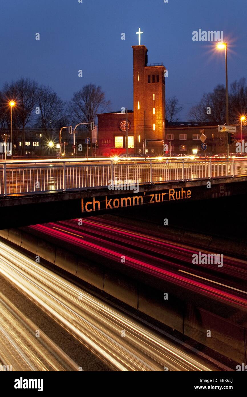 highway A40 with light streaks and bridge labeled 'Ich komm zur Ruhe - I get some peace' in evening light, Germany, North Rhine-Westphalia, Ruhr Area, Bochum Stock Photo