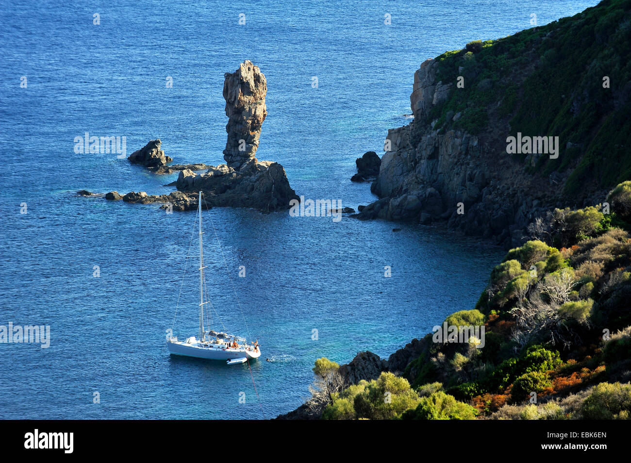 sail boat at rocky coast of Capo Rosso, France, Corsica Stock Photo