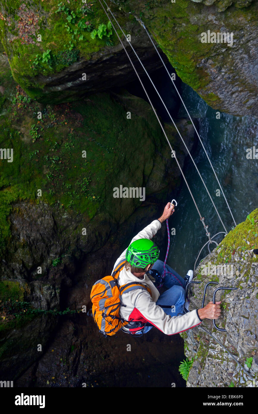 hiker crossing a ravine on steel rope, France, Mercantour National Park, Lantosque Stock Photo