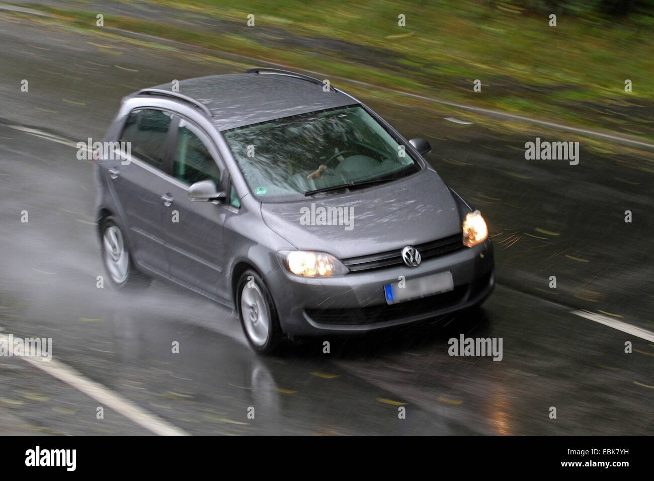 car on rainy street, Germany Stock Photo