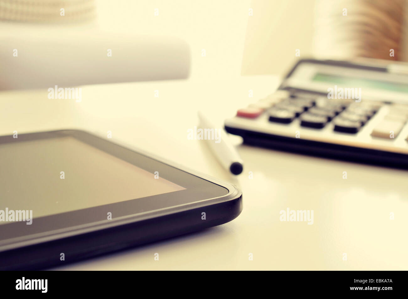 closeup of a desk with a tablet and a calculator in an office with a nice atmosphere Stock Photo