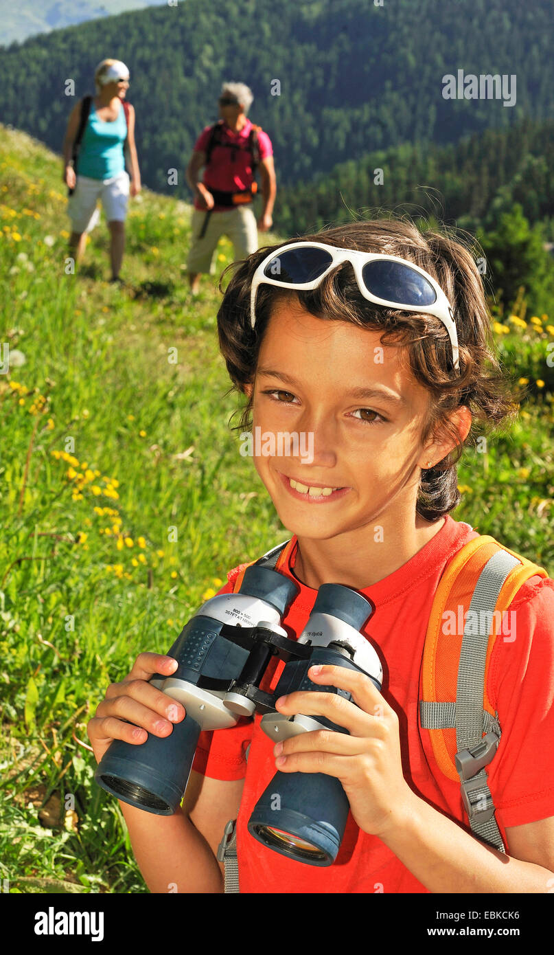 boy holding a spyglass in the hands, France, Savoie Stock Photo